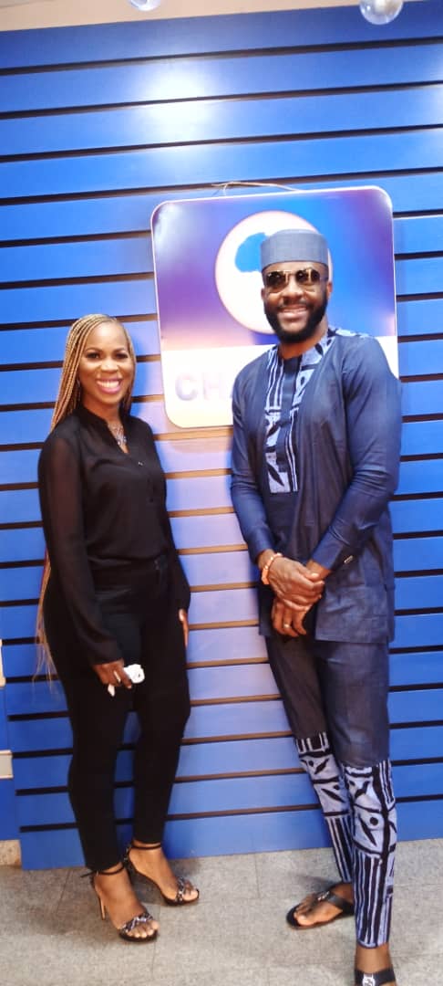 Ommo Clark with the host of Channels TV's Rubbin Minds in the studio, with the Channels TV logo visible behind