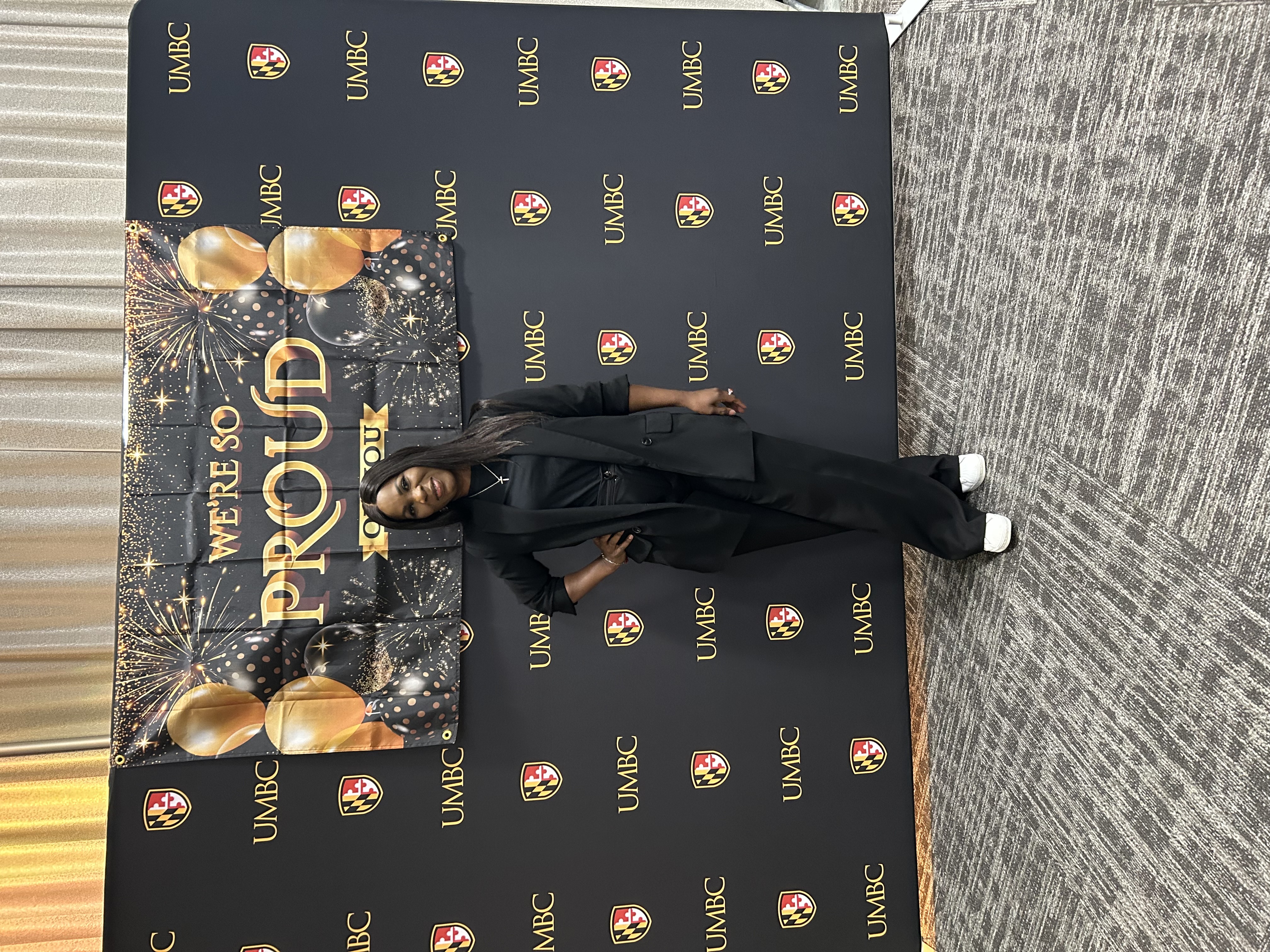 Ommo Clark at UMBC, 2025, in front of a UMBC step-and-repeat